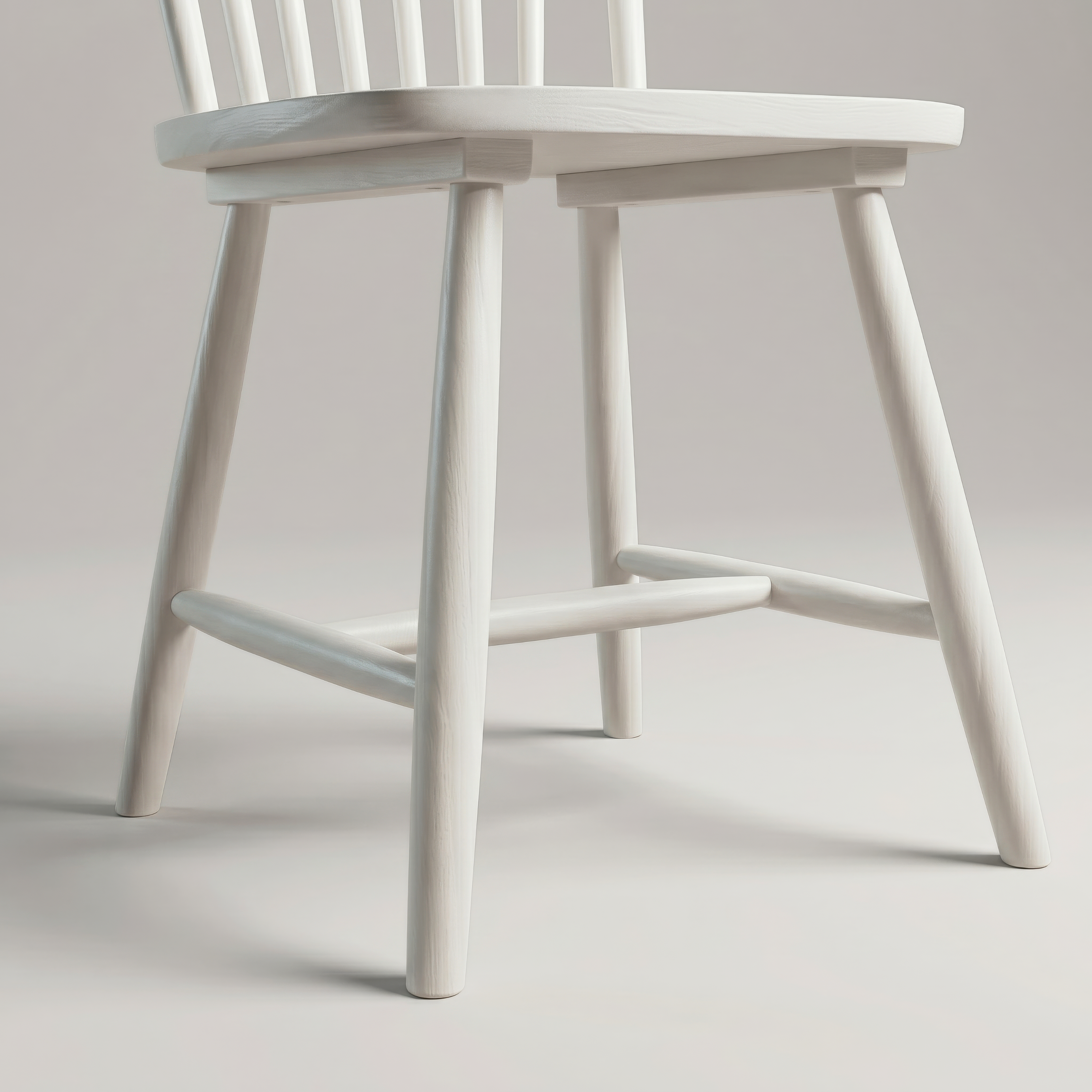 Close up of the turned legs and stretchers under the Linnea Soft White dining chair seat
